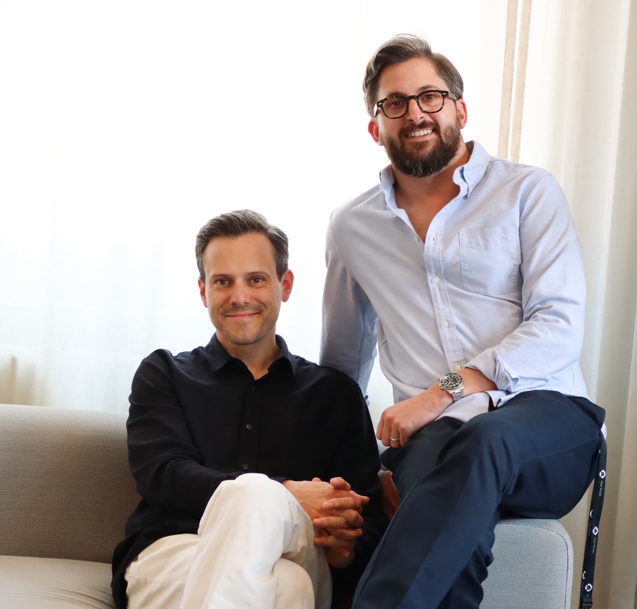 Sebastian Broms and Joseph Dickenson in a relaxed portrait, smiling indoors in a bright setting.