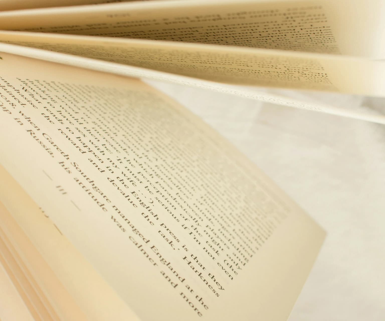Close-up of open book pages with printed text in English.