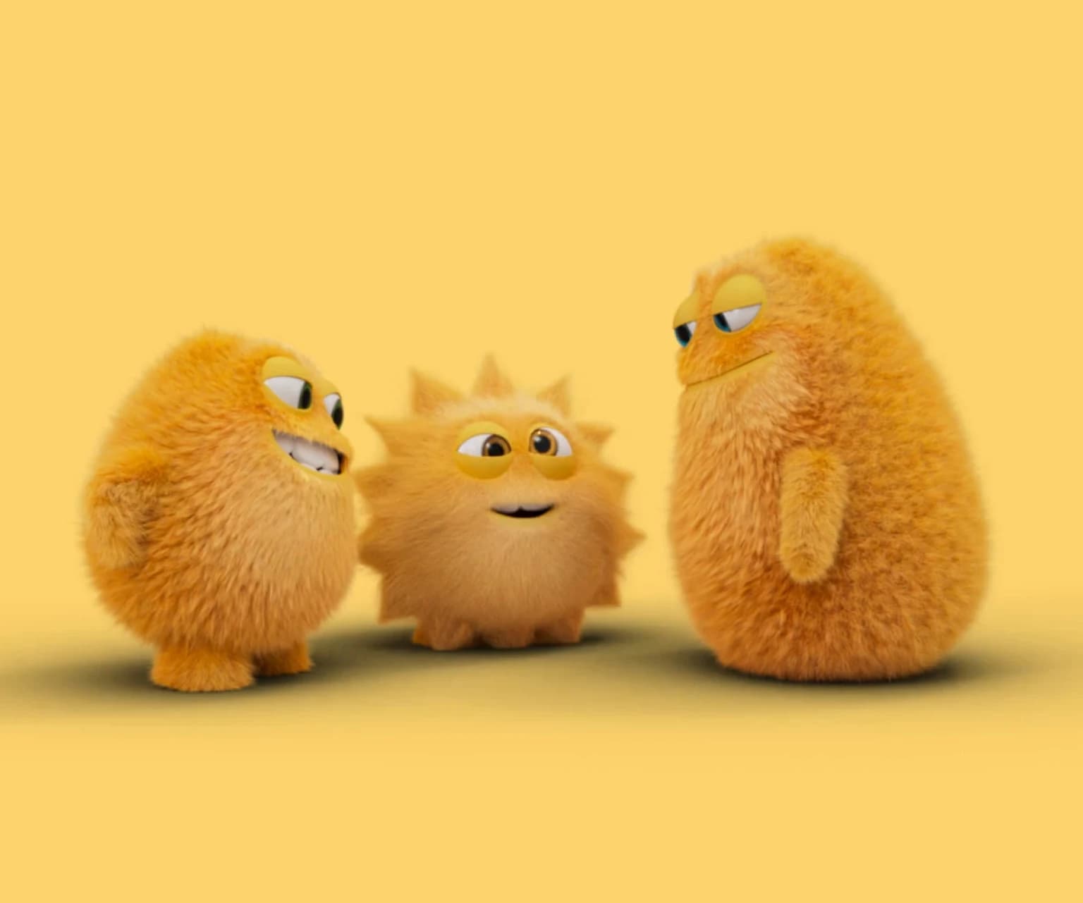 Three cheerful yellow furry animated mascots standing together on a yellow background, representing friendly and playful brand characters.