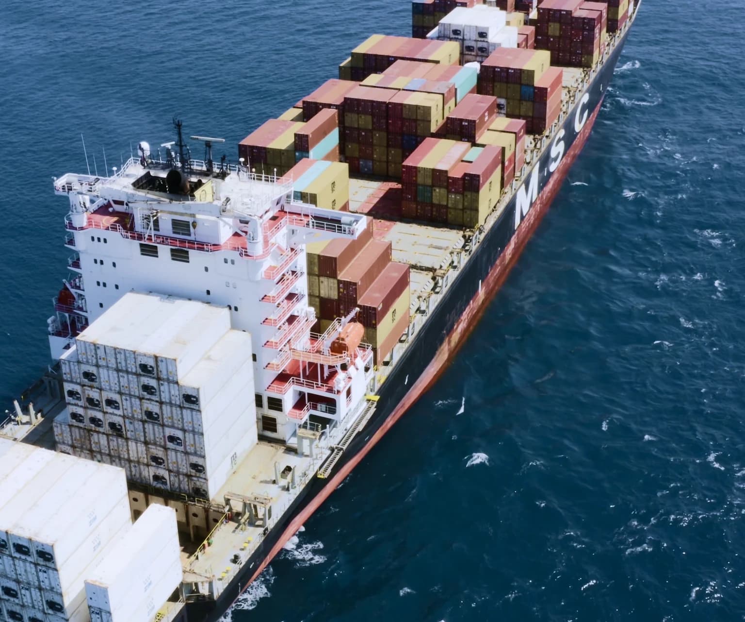Large MSC cargo ship transporting stacked shipping containers across the ocean.